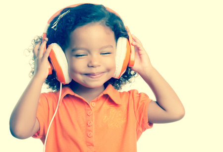 38053728 - small girl listening to music on her big headphones